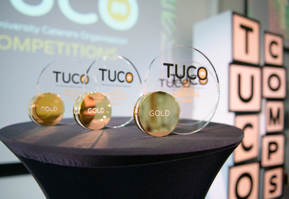 Image of trophies on a pedestal, the trophies say TUCO GOLD