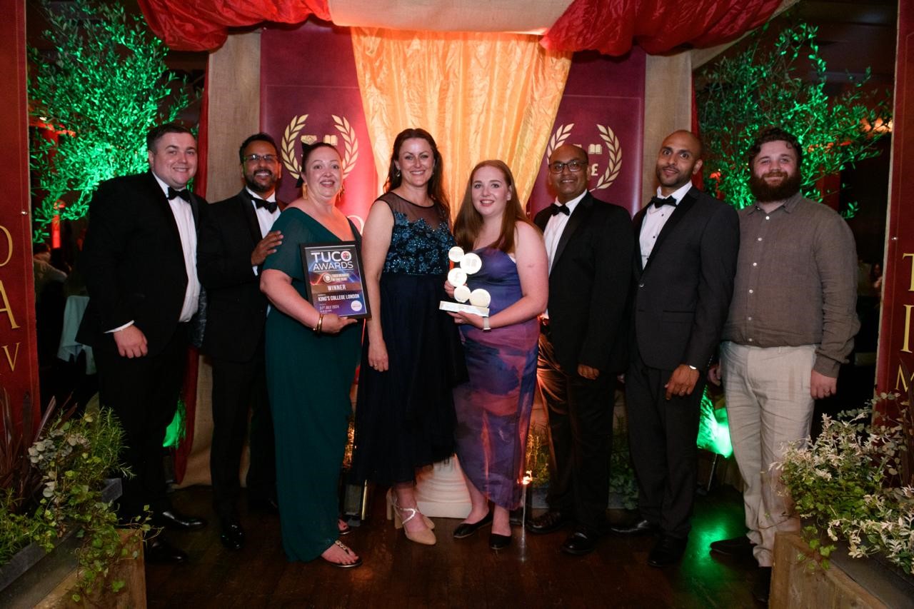 Group of people holding an award